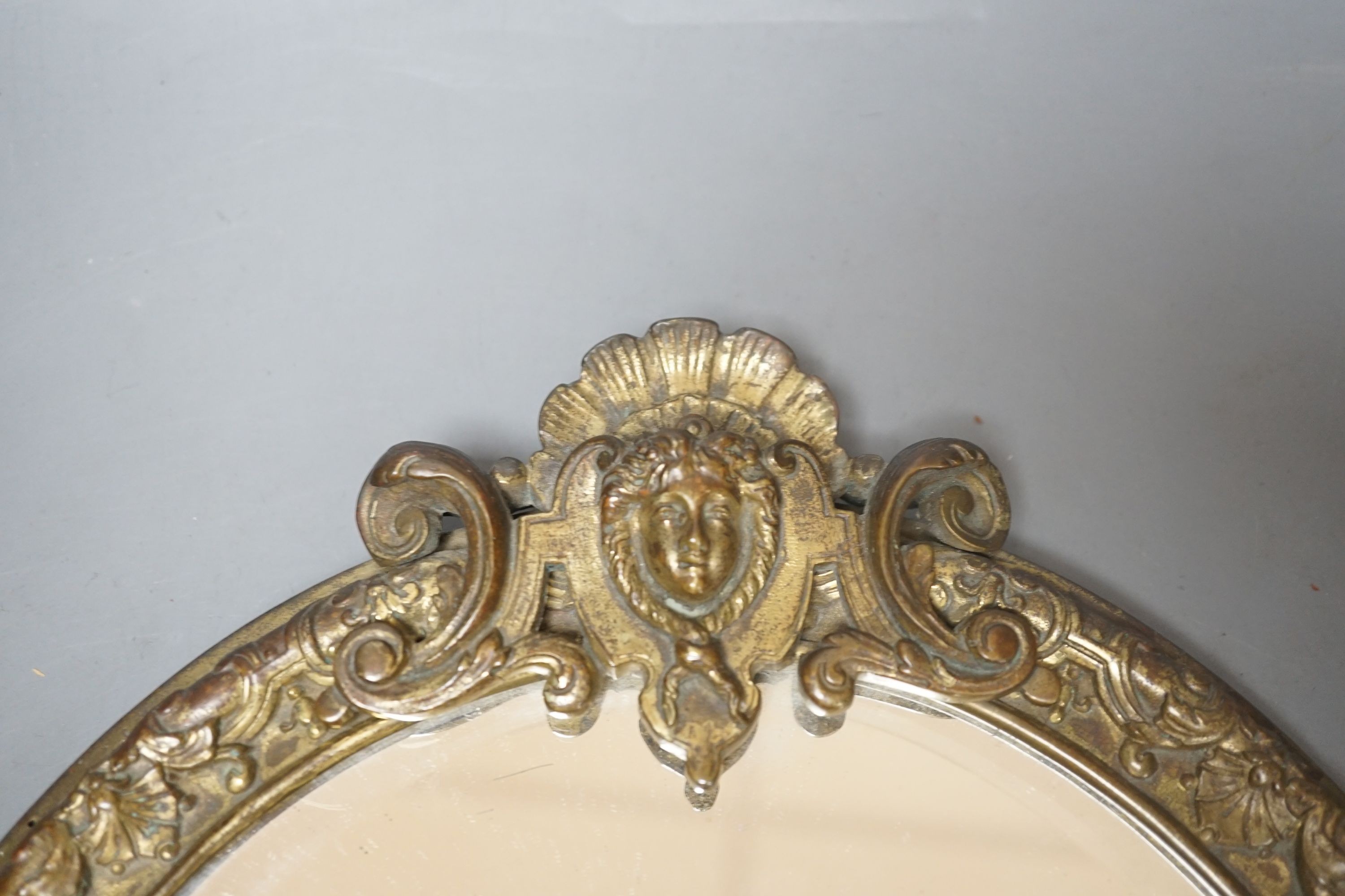 An early 20th century decorative gilt metal mirror, 41 cms high